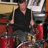 In this shot of Tom drumming you can see one of our posters and a pint of real ale.